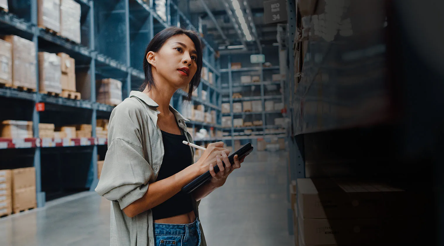 A warehouse team member checking inventory in a fulfillment centre